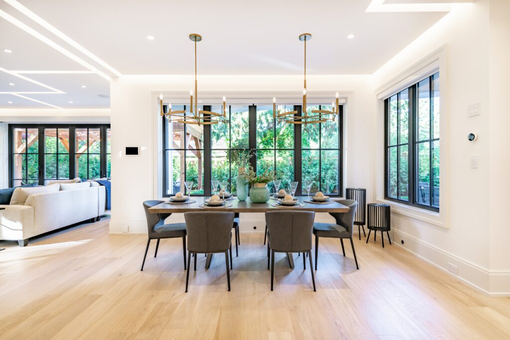 a sleek, modern dining space with windows on two sides that let in natural light